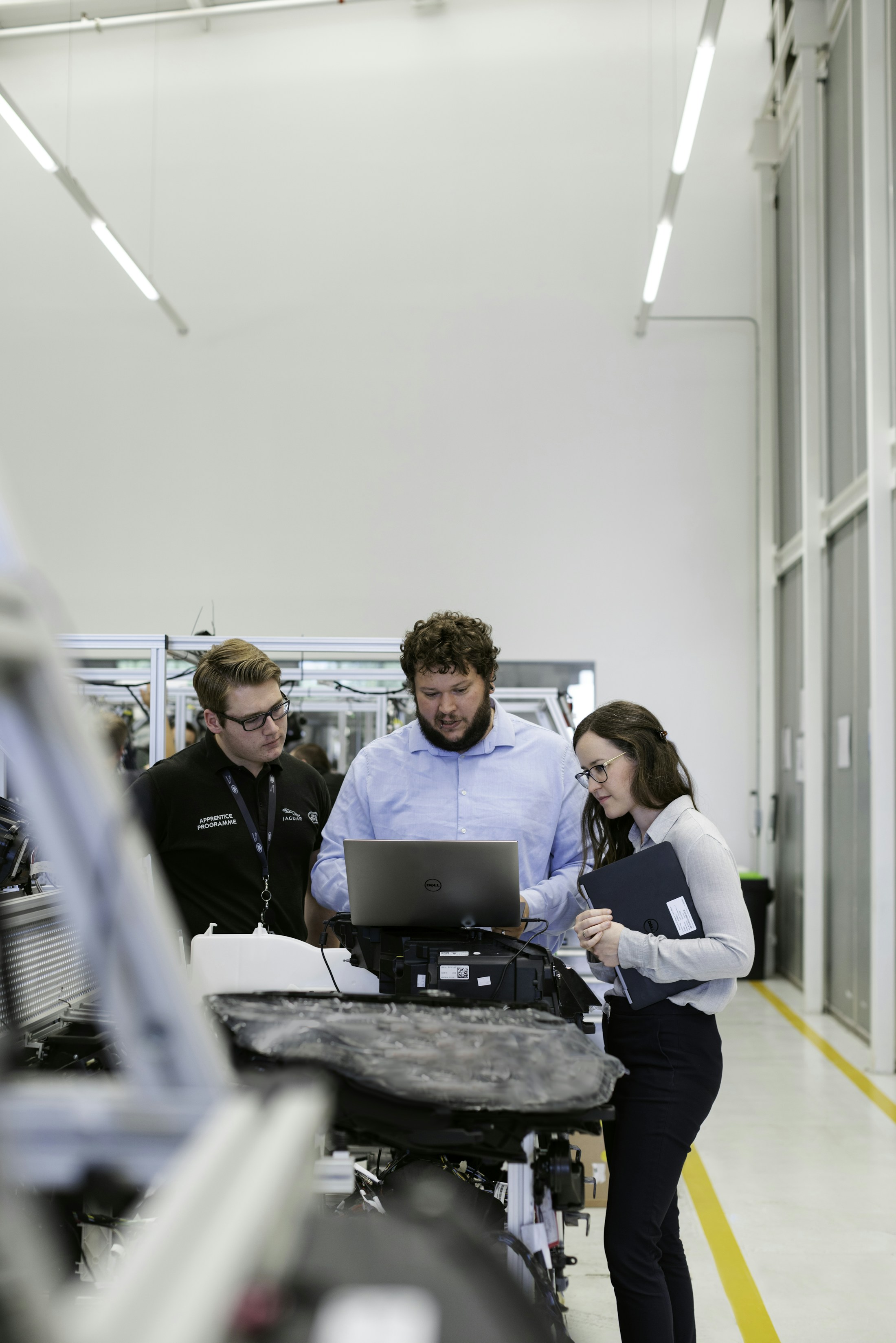 People examining equipment in a technical workshop